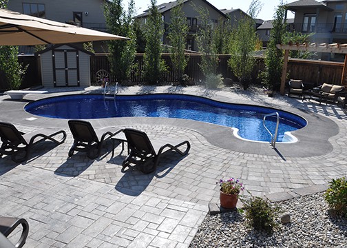 Complete landscaping job involving a pool, pavers, fencing, retaining walls, and arbor